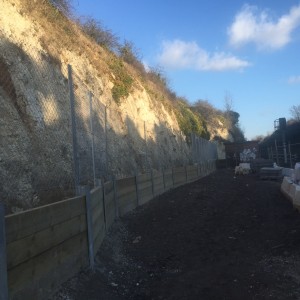 A substantial retaining wall was needed to protect the working area and the railway line from stones falling from the chalk cliff